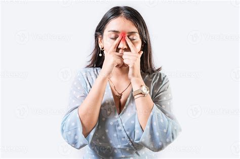Girl with nasal bridge headache. Sinus pain concept. Young woman with