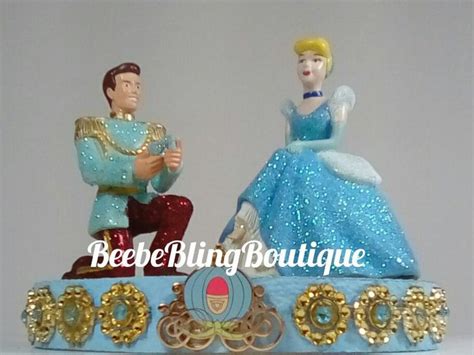 a figurine of a man and woman sitting on top of a blue carriage