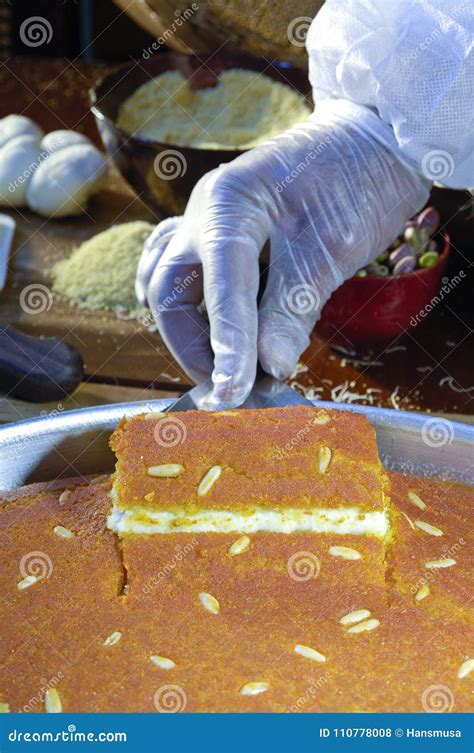 Cutting Kunafa or Kinafa, Arabic Sweets with Cheese for Ramadan a Stock ...