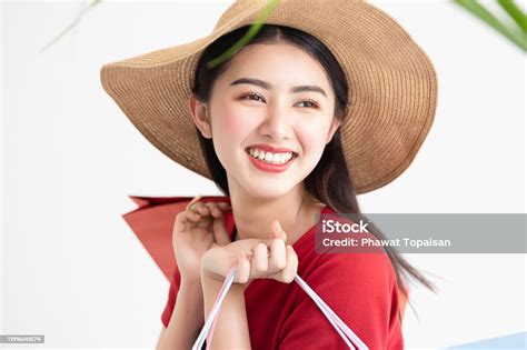 Portrait Of Beautiful Young Asian Woman Wearing Red Long Dress Holding