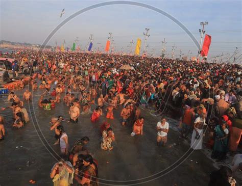 Image Of Crowd Of Hindu Devotees Taking Holy Bath In Triveni Sangam