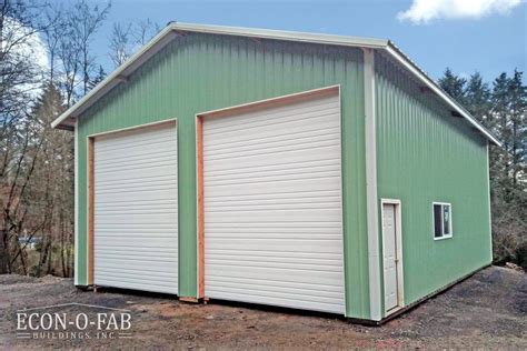 A Green Garage With Two Doors On The Side