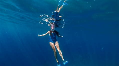 Fashionable And Athletic Girl Diver Alone In The Depths Of The Ocean