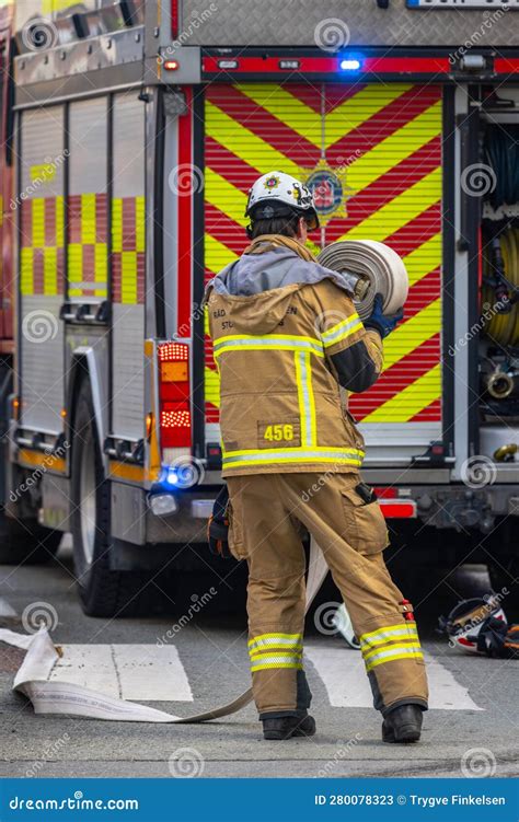 Firefighter Rolling A Hose After Putting Out A Fire Editorial Stock