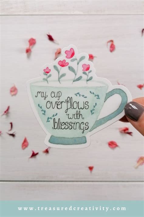 Someone Holding Up A Sticker That Says My Cup Overflows With Blessing