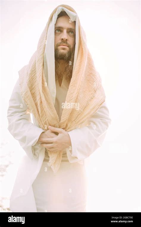 Jesus Christ Standing Clothed In His Traditional White Robe Against Sky