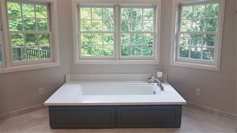 Soaking Tub With Quartz Deck And Wood Panel Surround Delta Dryden