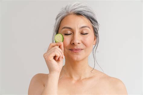 Mature Shirtless Woman With Grey Hair Showing Piece Of Cucumber Stock Photo Image Of