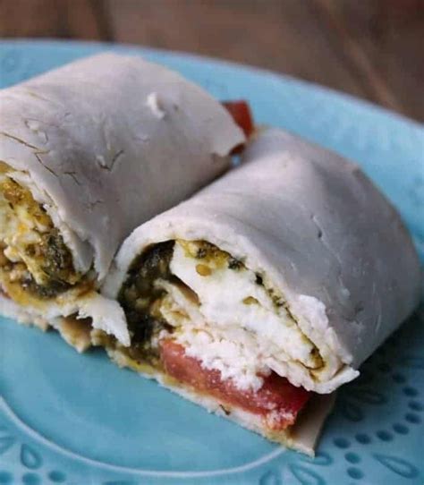 Two Burritos Cut In Half On A Blue Plate