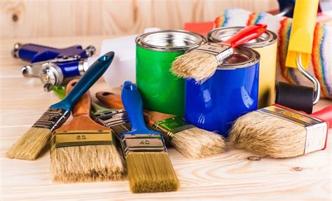 Several Paint Cans And Brushes On A Table