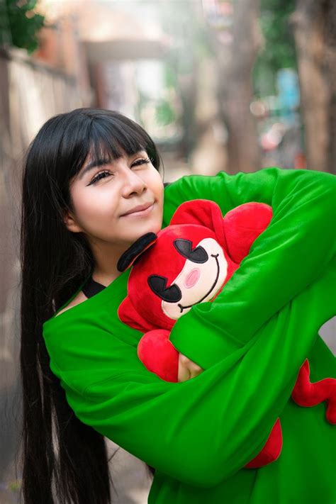 a woman with long black hair is holding a red teddy bear and smiling at ...