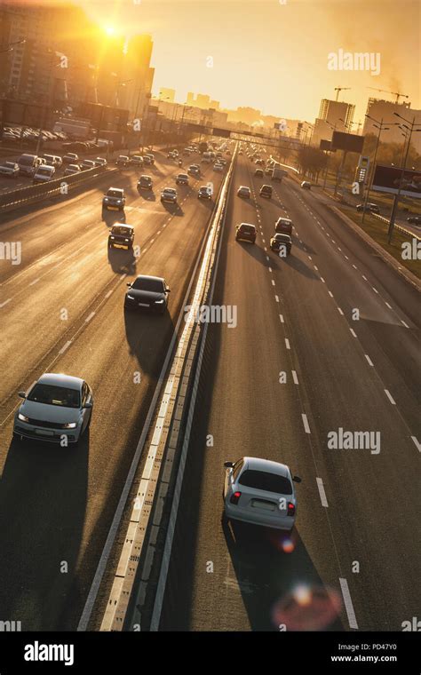 Cars on highway. Sunset cityscape. Contrejour wallpaper Stock Photo - Alamy