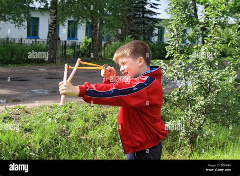 Boy With Slingshot Stock Photo Alamy