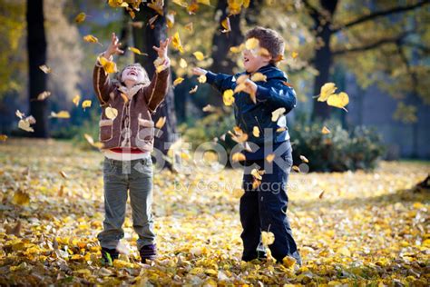 Children Playing With Leaves IN Autumn Park stock photos - FreeImages.com