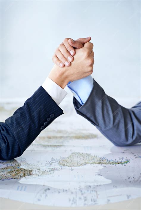 Premium Photo | Map arm wrestle and power struggle with business people