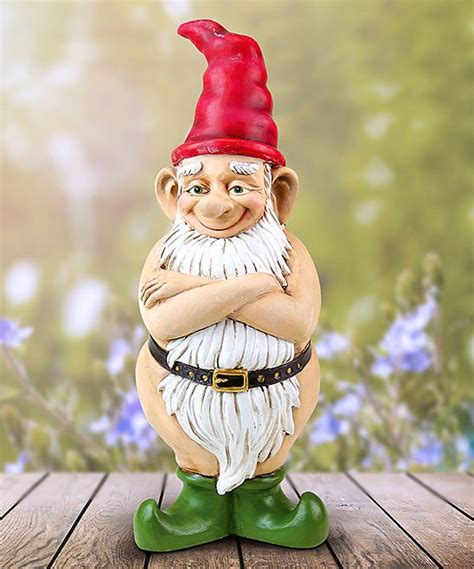 A Gnome Figurine Sitting On Top Of A Wooden Table