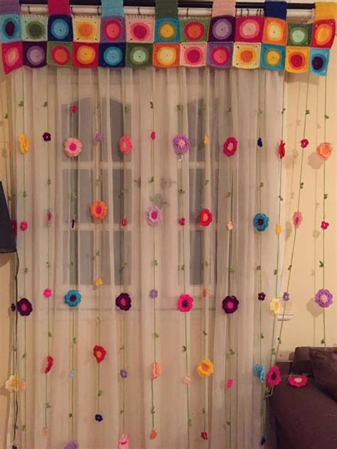 The Curtain Is Decorated With Colorful Flowers And Ribbons Hanging From