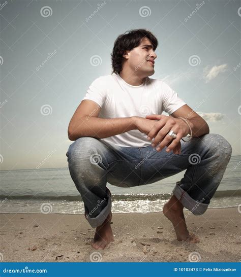 Young Man Squatting On The Sand Stock Image Image Of Male Hunk 10103473