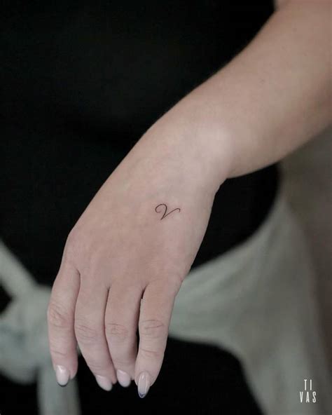 Minimalistic Style Letter V Tattoo Located On The