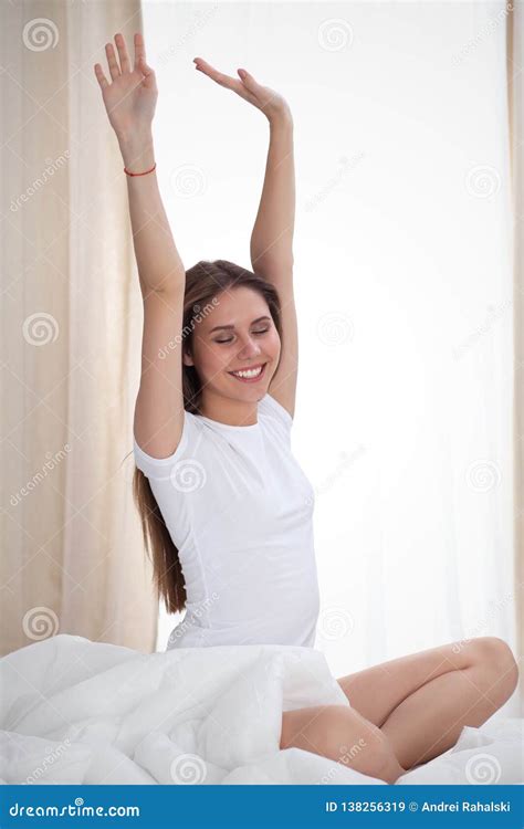 Woman Stretching In Bed After Wake Up Entering A Day Happy And Relaxed