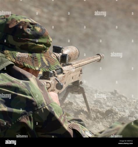 A British Royal Marine Commando Sniper Fires A High Power Rifle Stock