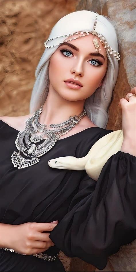 A Woman With White Hair Wearing A Black Dress And Silver Jewelry Is