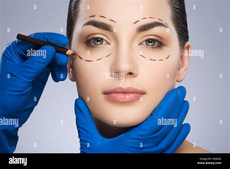 Plastic Surgeon Drawing Dashed Lines Under Eye Stock Photo Alamy