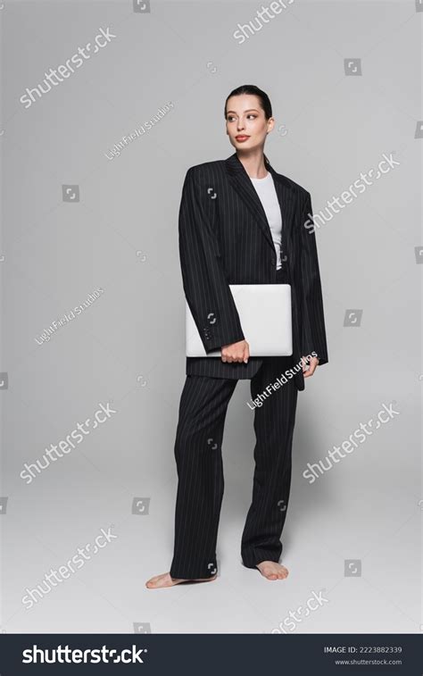 Stylish Barefoot Woman Suit Holding Laptop Stock Photo 2223882339 | Shutterstock