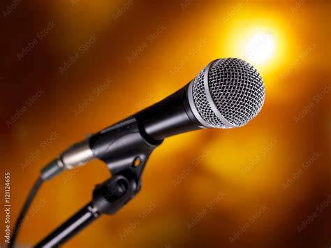 Microphone on stand against a colorful background Stock Photo | Adobe Stock