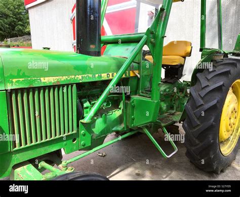 An Old John Deere Tractor Outside A Barn Stock Photo Alamy