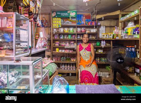 An Owner Smiling Inside Her Home Store Locally Called Sari Sari Store In Batangas Philippines