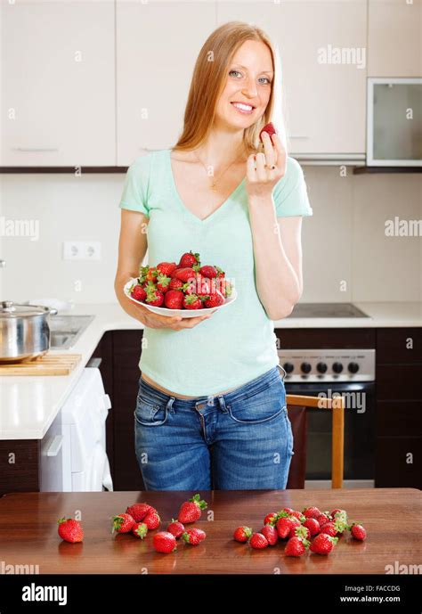 Happy Blonde Long Haired Woman Eating Strawberries Stock Photo Alamy