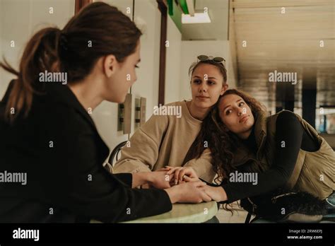 Upset Brunette Girl Telling A Story To Her Friends While They Are