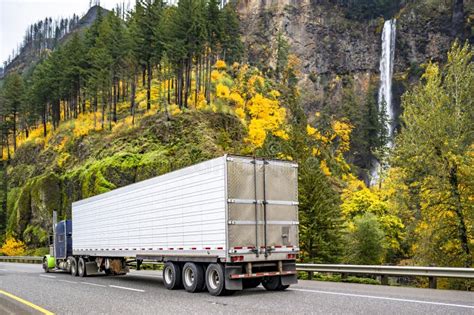 Blue And Green Classic Big Rig Semi Truck Transporting Cargo In Reefer