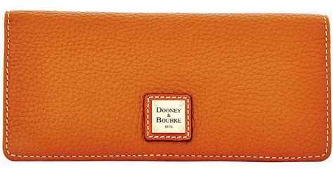 Dooney Bourke Pebble Grain Slim Wallet In Orange Lyst