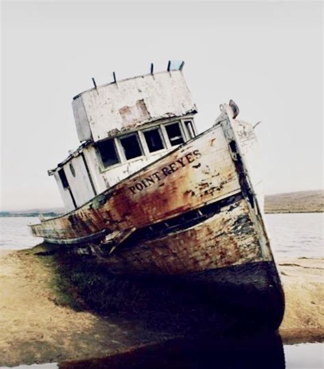 Rusted Boat On Sandy Beach