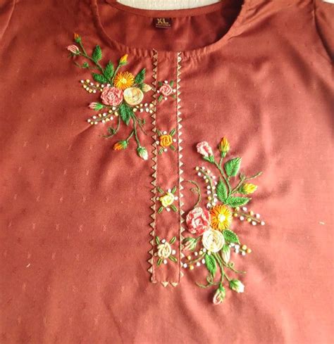 An Orange Shirt With Flowers And Pearls On It