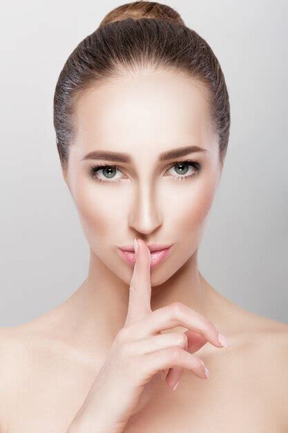 Premium Photo Beautiful Brunette Woman Showing Silence Gesture Secret Of Beauty