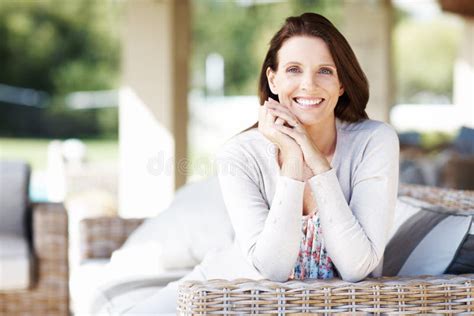 Loving Her Outdoor Space An Attractive Brunette Having A Relaxing Time Outdoors Stock Image
