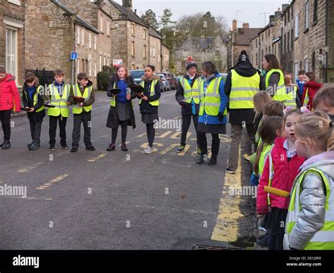 School Children Ready With Frying Pans And Pancakes At Starting Line At