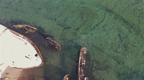 Aerial Top View Of Old Wrecked Fishing Ships Drowned At The Sea Shore