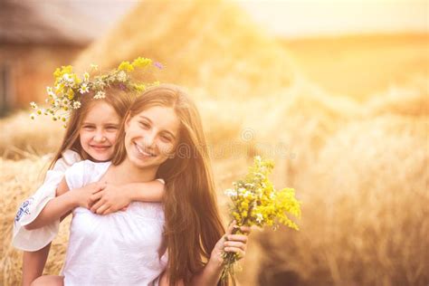 Two Cute Sisters With Flowers Stock Photo Image Of Cute Happy 157375050