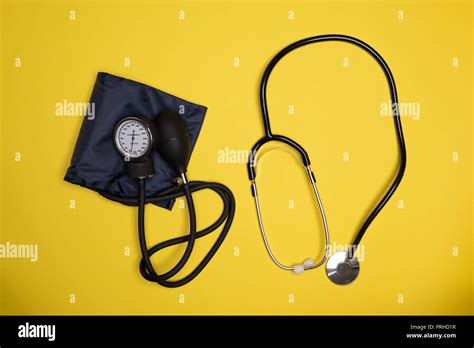 Blood Pressure Monitor And Stethoscope Against Orange Background