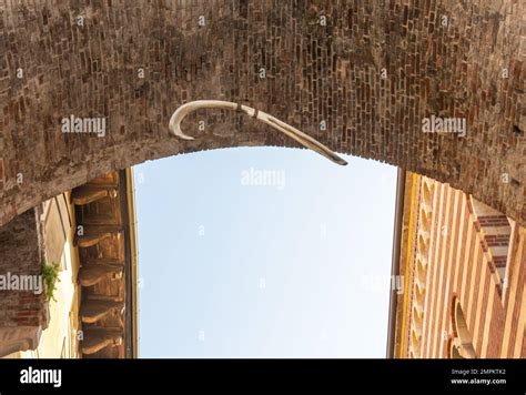 view of the famous whale's rib suspended over an archway between Piazza delle Erbe and Via della ...