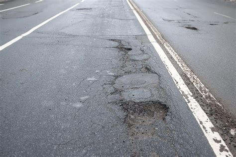 Premium Photo Broken Asphalt Road In City And Untimely Repair Pothole