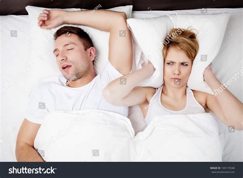 Snoring Man And Young Woman. Couple Sleeping In Bed. Stock Photo 130173548 : Shutterstock