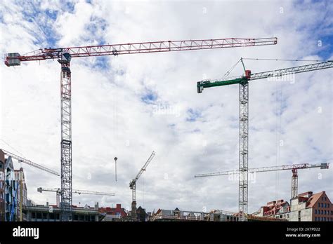 Several Tall Construction Tower Cranes In City Construction Sites