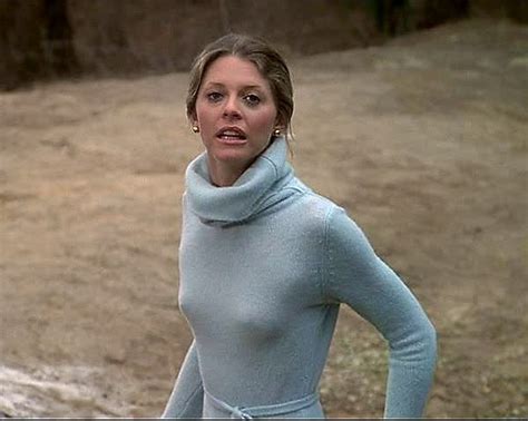 A Woman In A Blue Turtle Neck Sweater