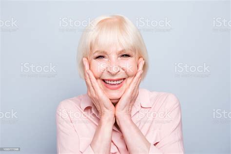 Old Adult Blonde Glad Excited Cheerful Astonished Lady Smiling Laughing Palms To Cheeks Over