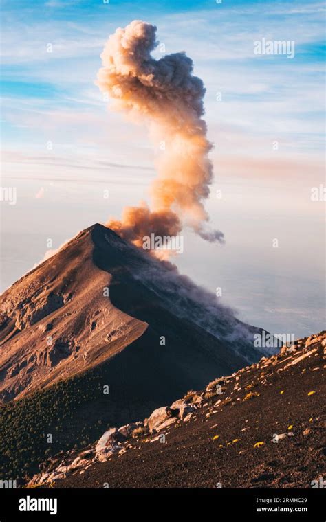 a smoke and ash plume erupts from the Fuego Volcano crater, as seen ...